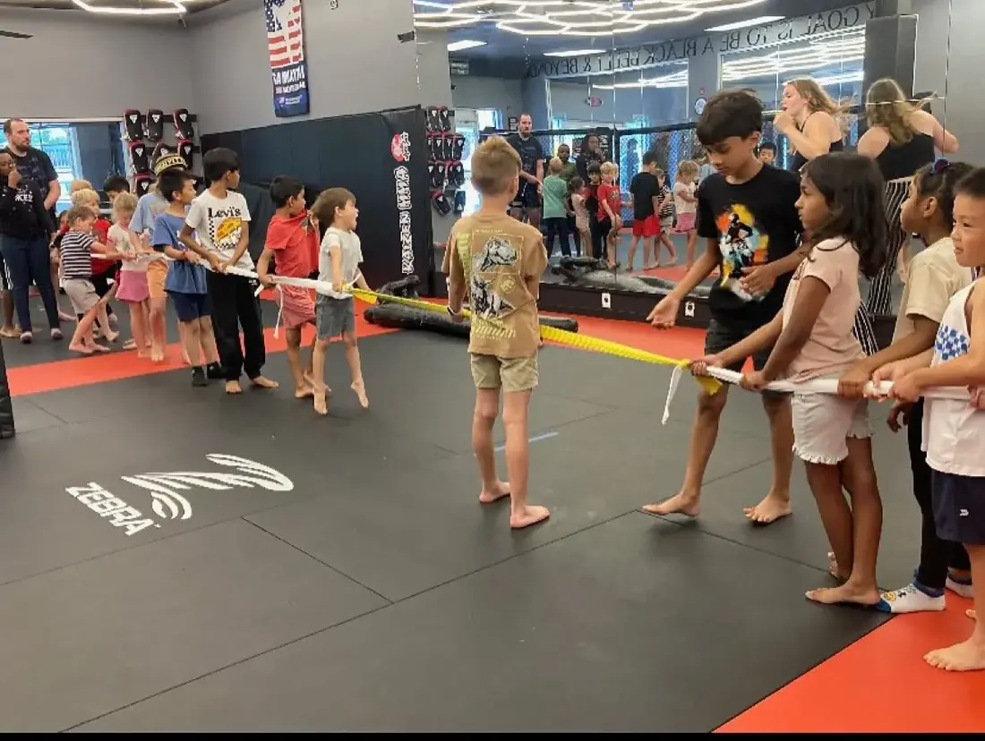 A group of children playing tug of war indoors