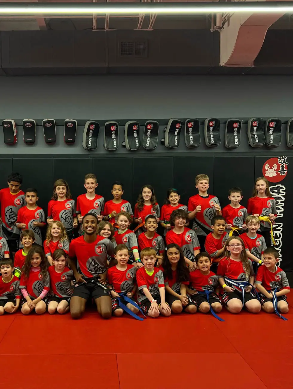 A large group of children sitting together on the mats after a session